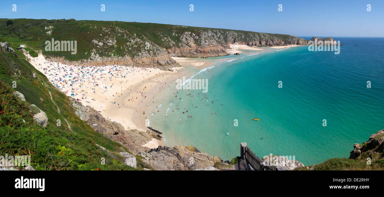 Above Porthcurno beach panorama on a busy sunny summer day in Cornwall UK. Stock Photo