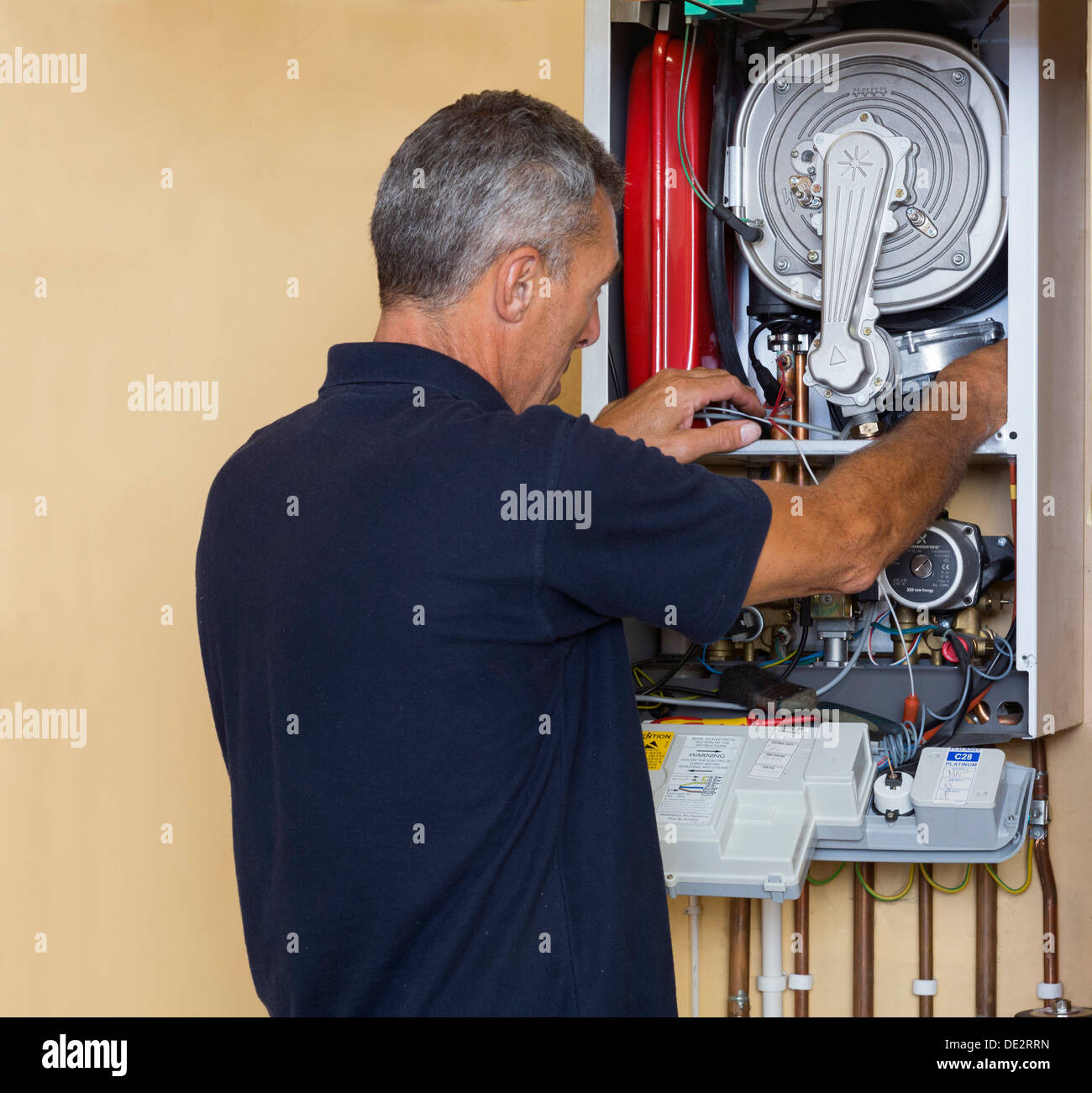 engineer servicing a gas boiler Stock Photo