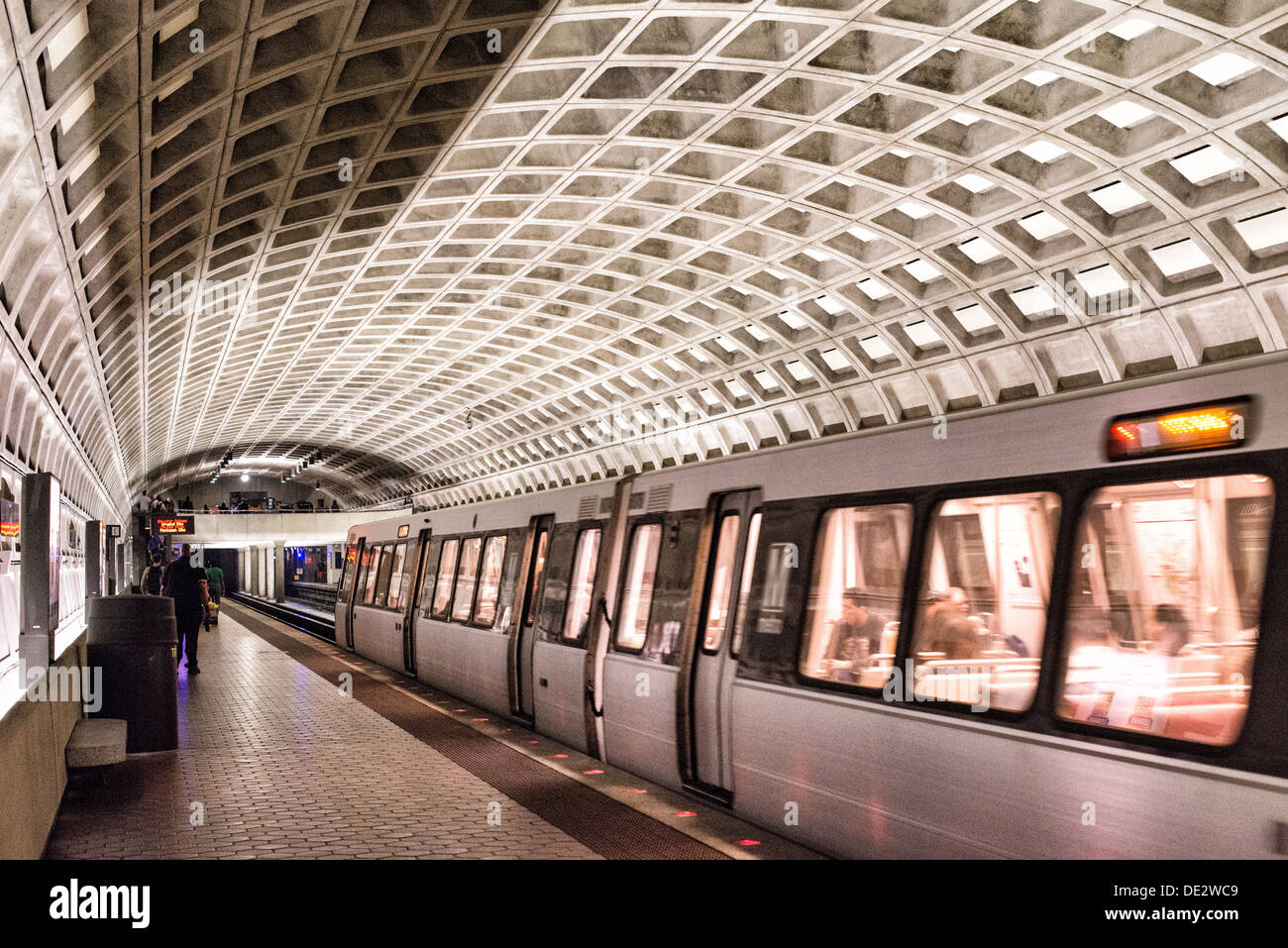 A train leaves the platform at one of the distinctive domed stations of the Washington Metropolitan Area Transit Authority subway system in the Washington DC area. This station is in Ballston, Arlington, a few stops out from downtown Washington DC. Stock Photo