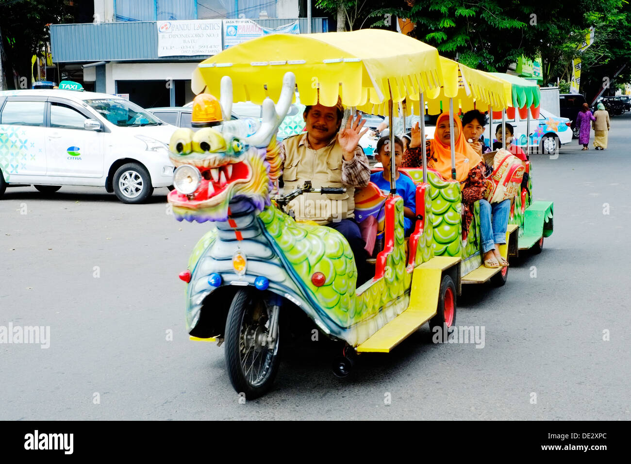 ornate and brightly coloured road train carrying passengers around batu town center malang java indonesia Stock Photo