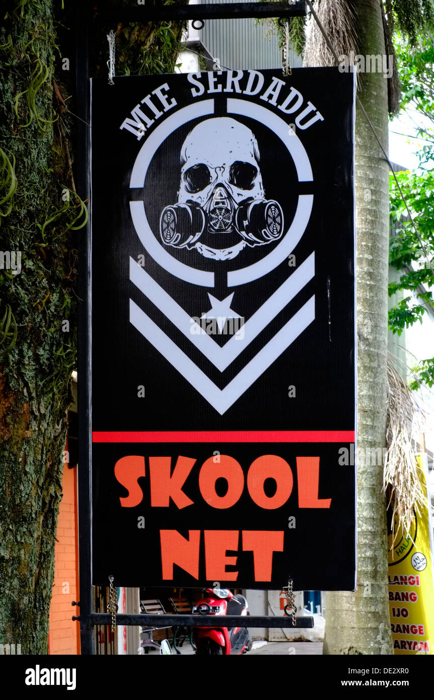 unusual misspelled sign advertising an internet cafe at the roadside batu malang java indonesia Stock Photo