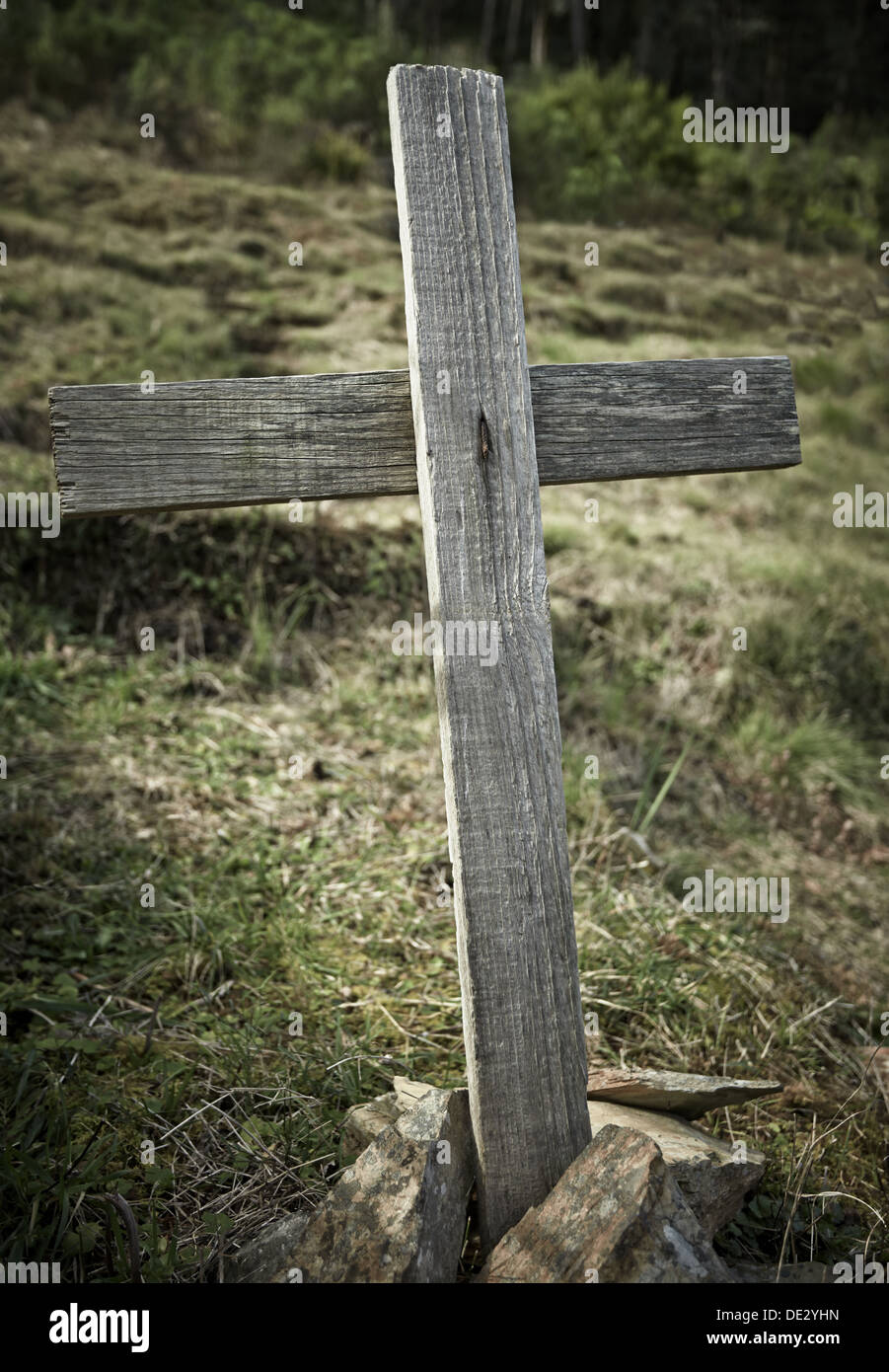 An old wooden cross marking a grave Stock Photo