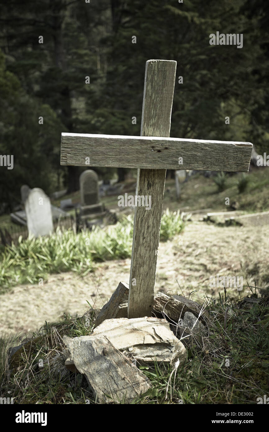 Solo wooden cross in old cemetery Stock Photo