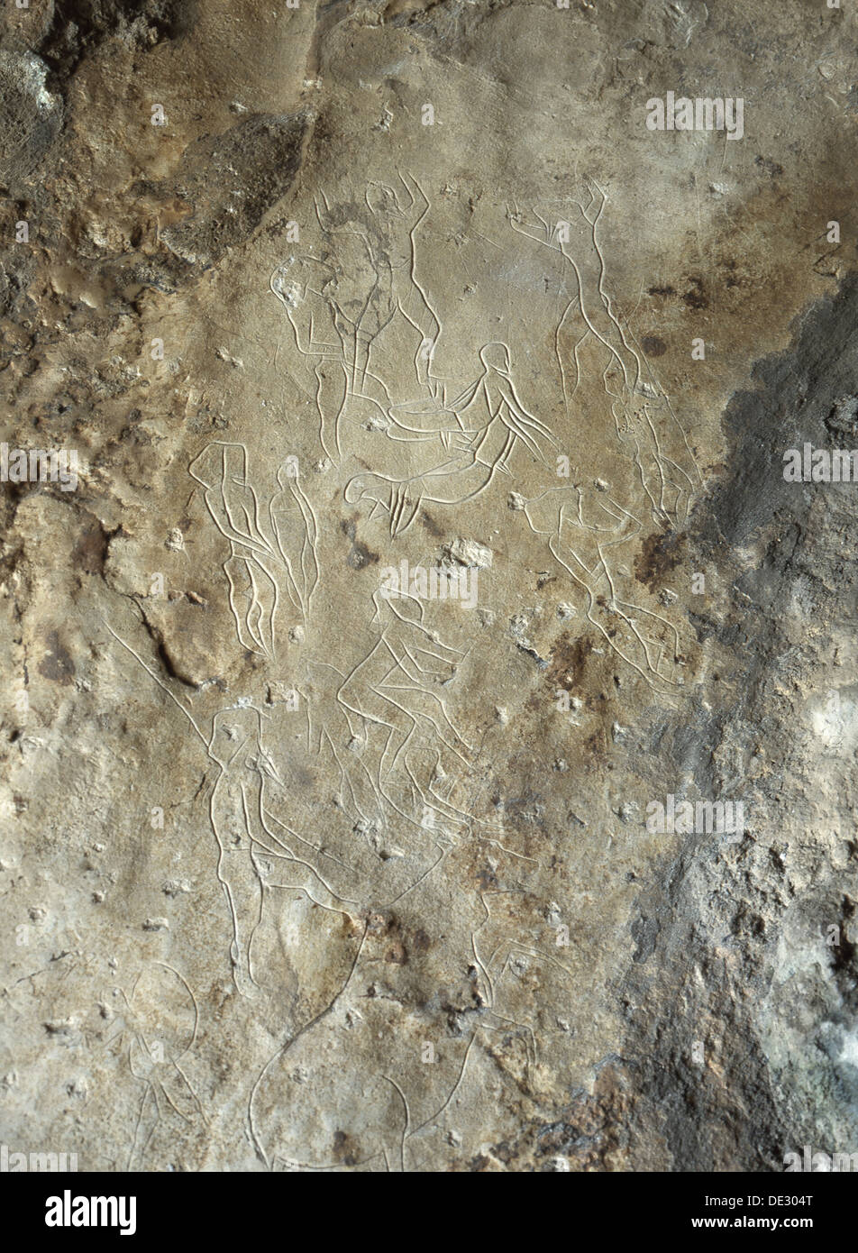 Images of male human figures engraved in limestone walls of the cave at Addaura. Stock Photo