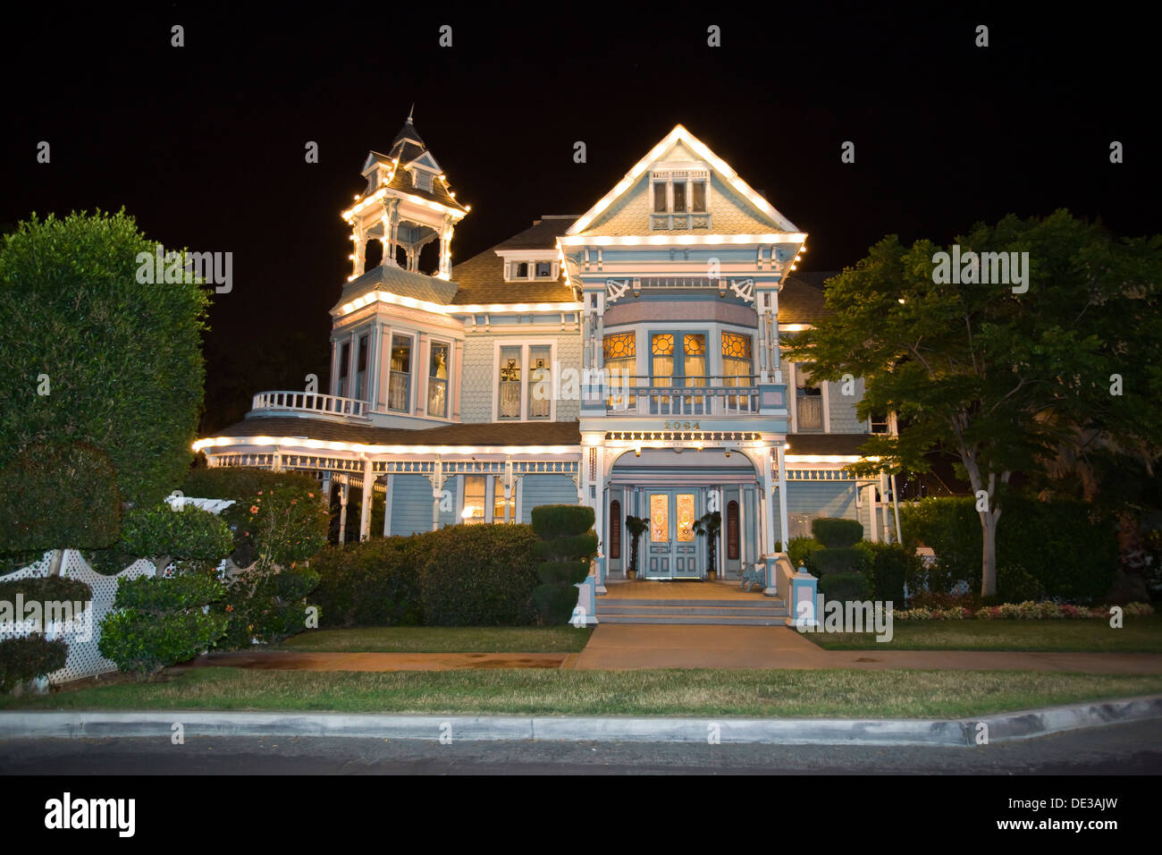 House exterior lined with decorative white lights Stock Photo