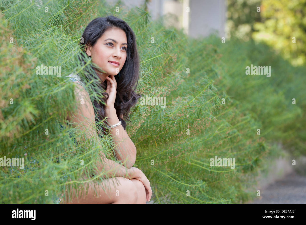 Young woman sitting outside Stock Photo