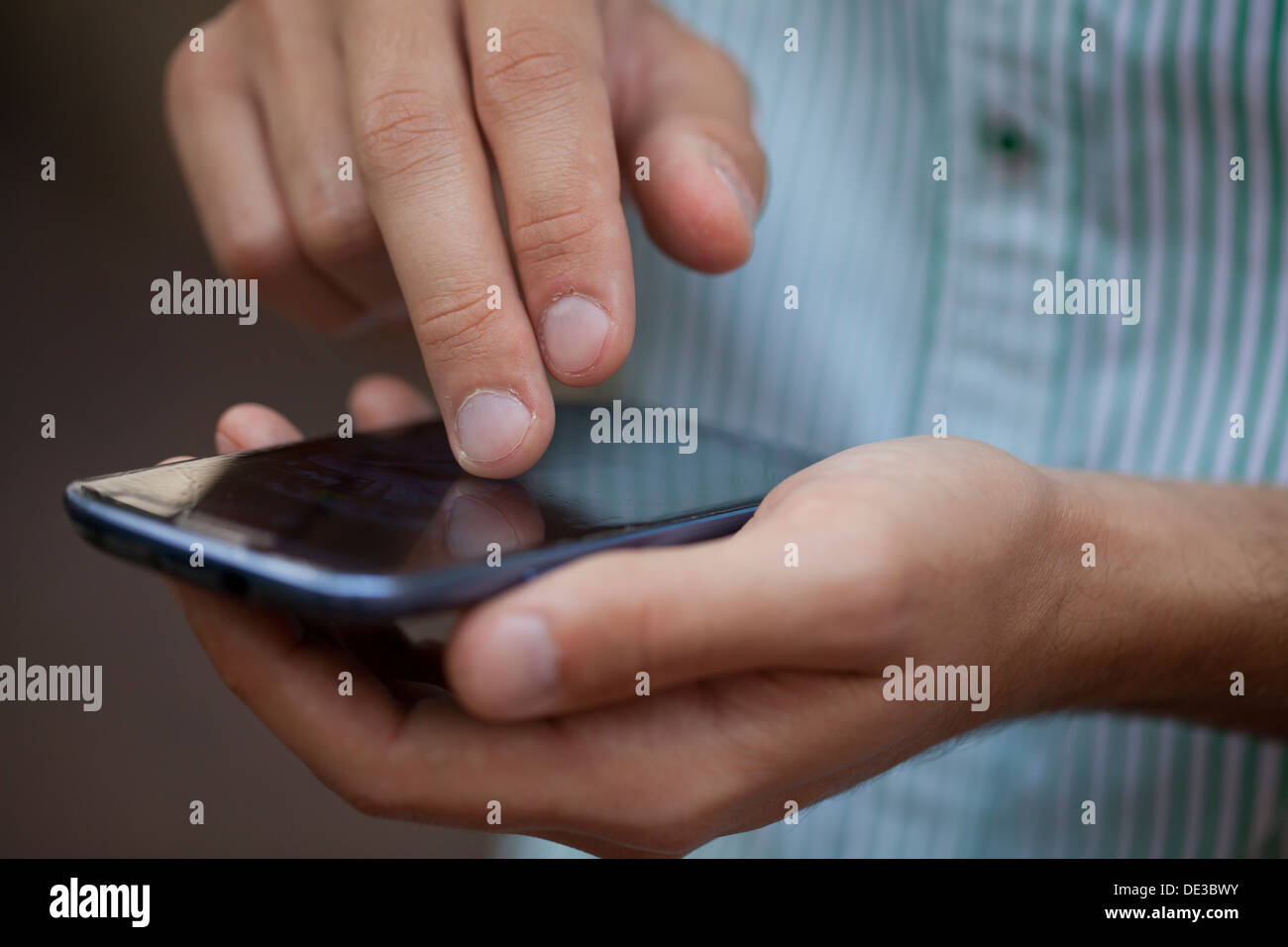 Closeup of man using smart phone Stock Photo
