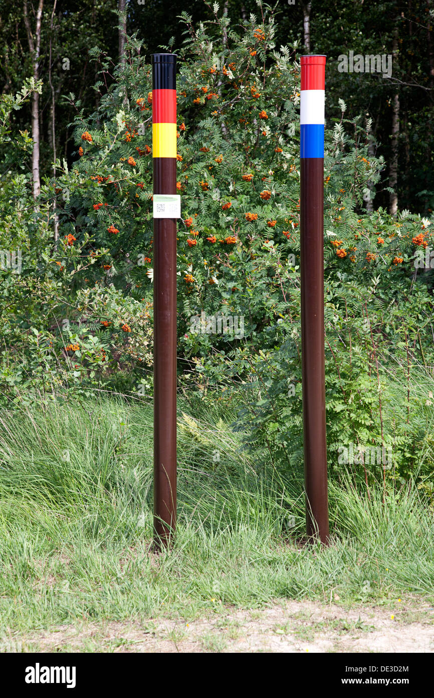 Iron poles on Dutch-German border with national colours, Bargerveen, Emmen, Drenthe, Netherlands Stock Photo