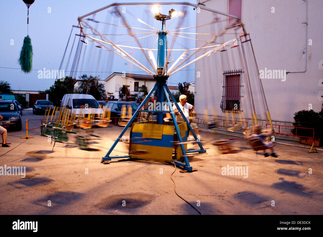 Babies get fun on old carousel seats. Loconia, Italy Stock Photo