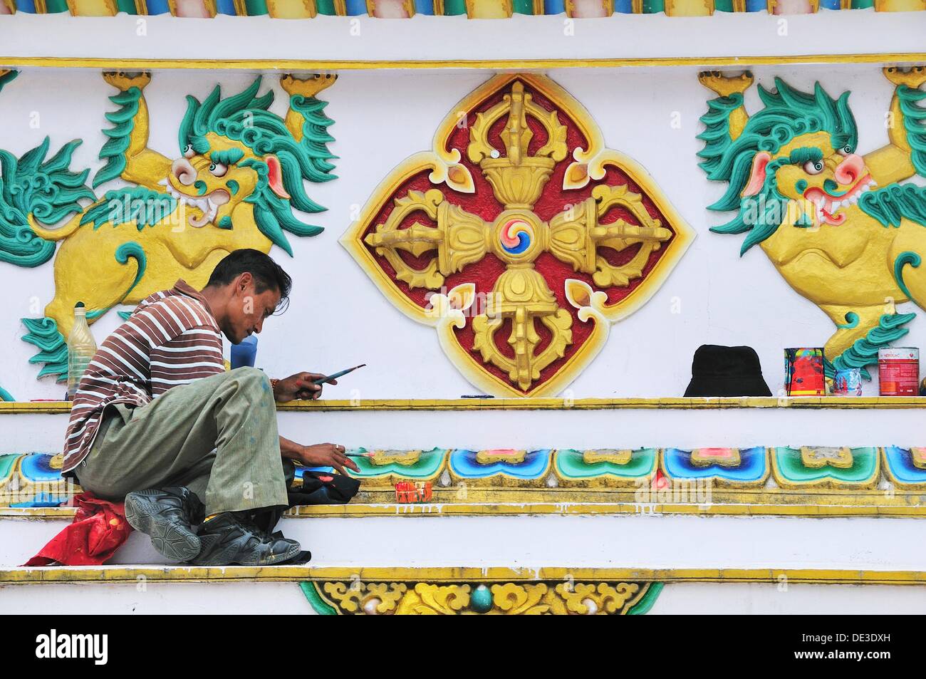 Man restore painting at Tsuglagkhang Temple Stock Photo