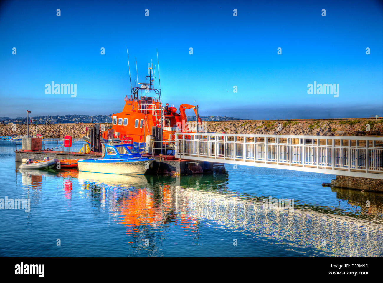 Brixham marina with blue sky and sea, boats and walkway in Devon England Torbay with reflection in HDR Stock Photo