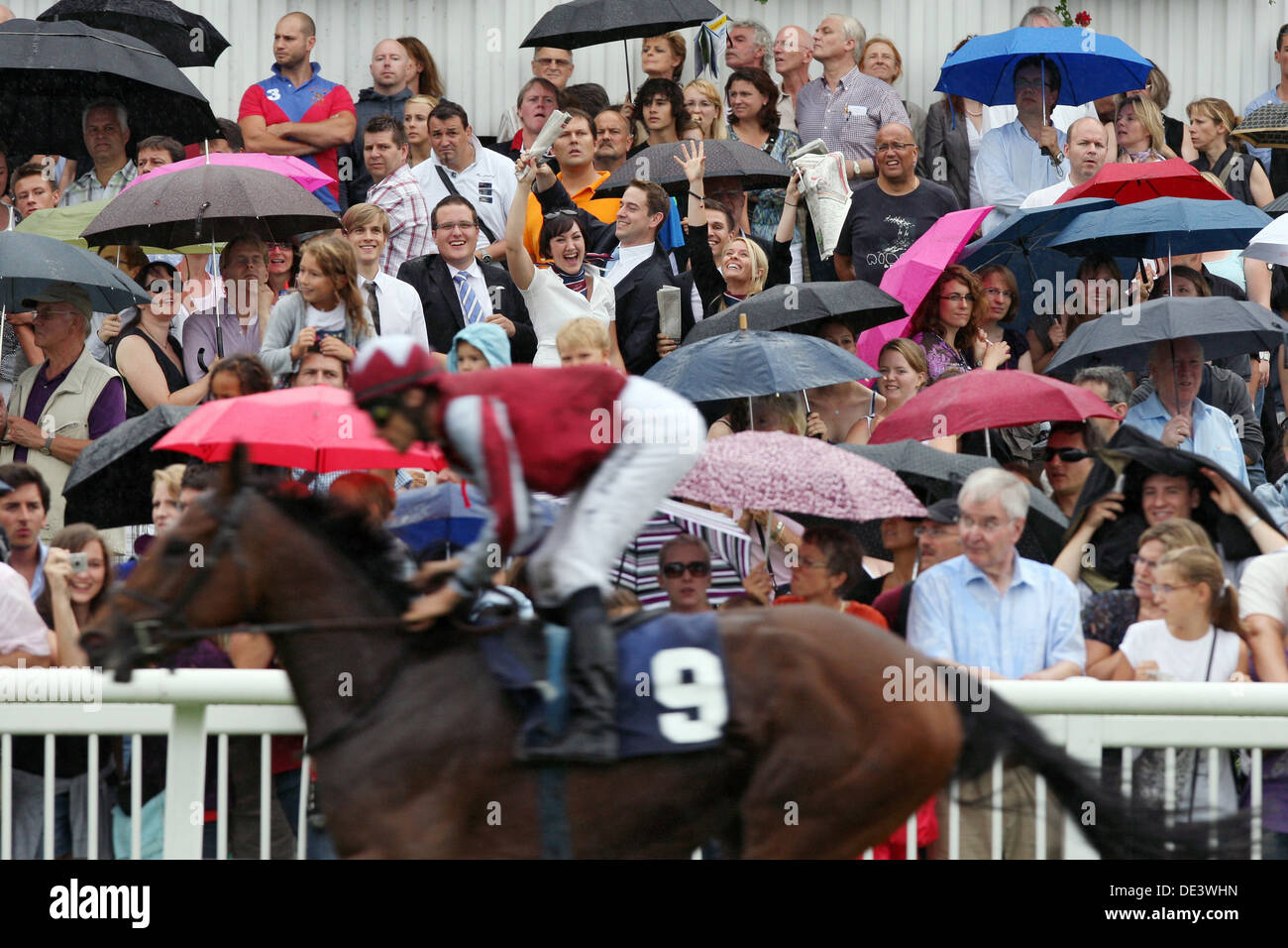Iffezheim, Germany, people follow a horse race in the rain Stock Photo