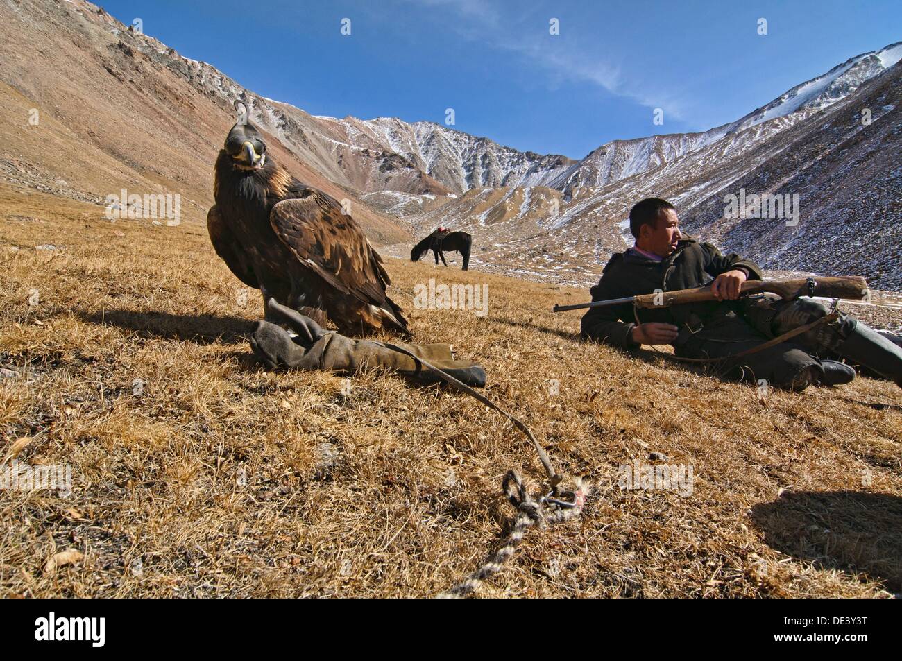 Kazakh Eagle Hunter And His Golden Eagle In The Altai Region