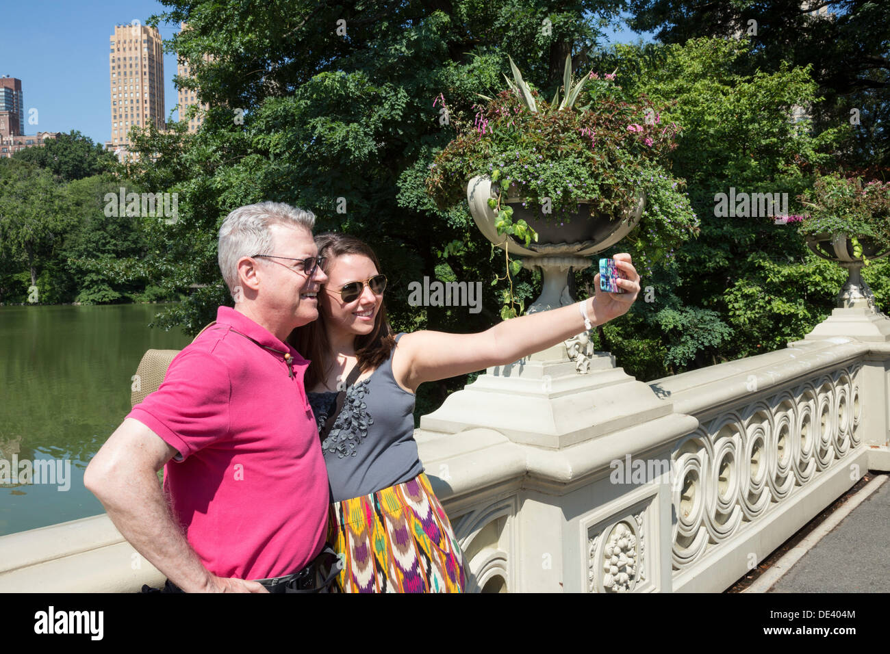 Tourists on Bow Bridge in Central Park, NYC Stock Photo