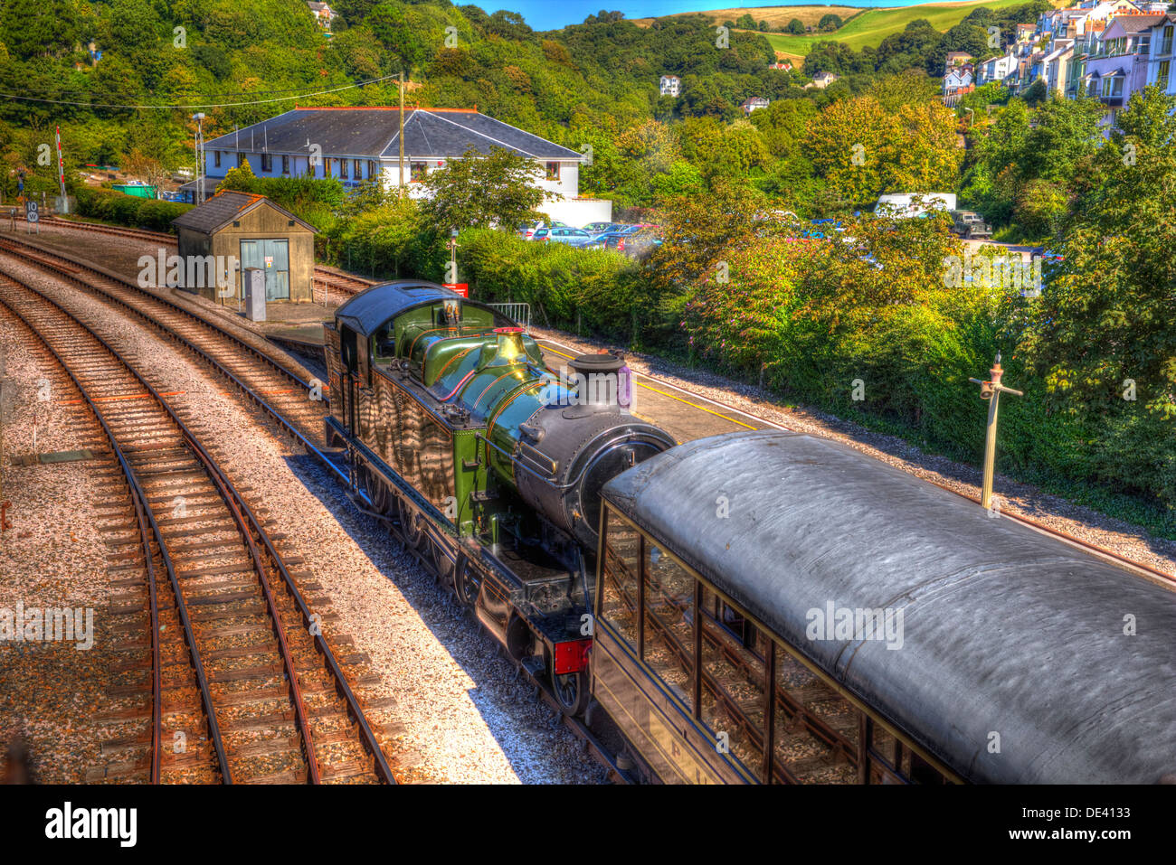 Green Steam Train and carriage in station with railway tracks in HDR like painting Stock Photo
