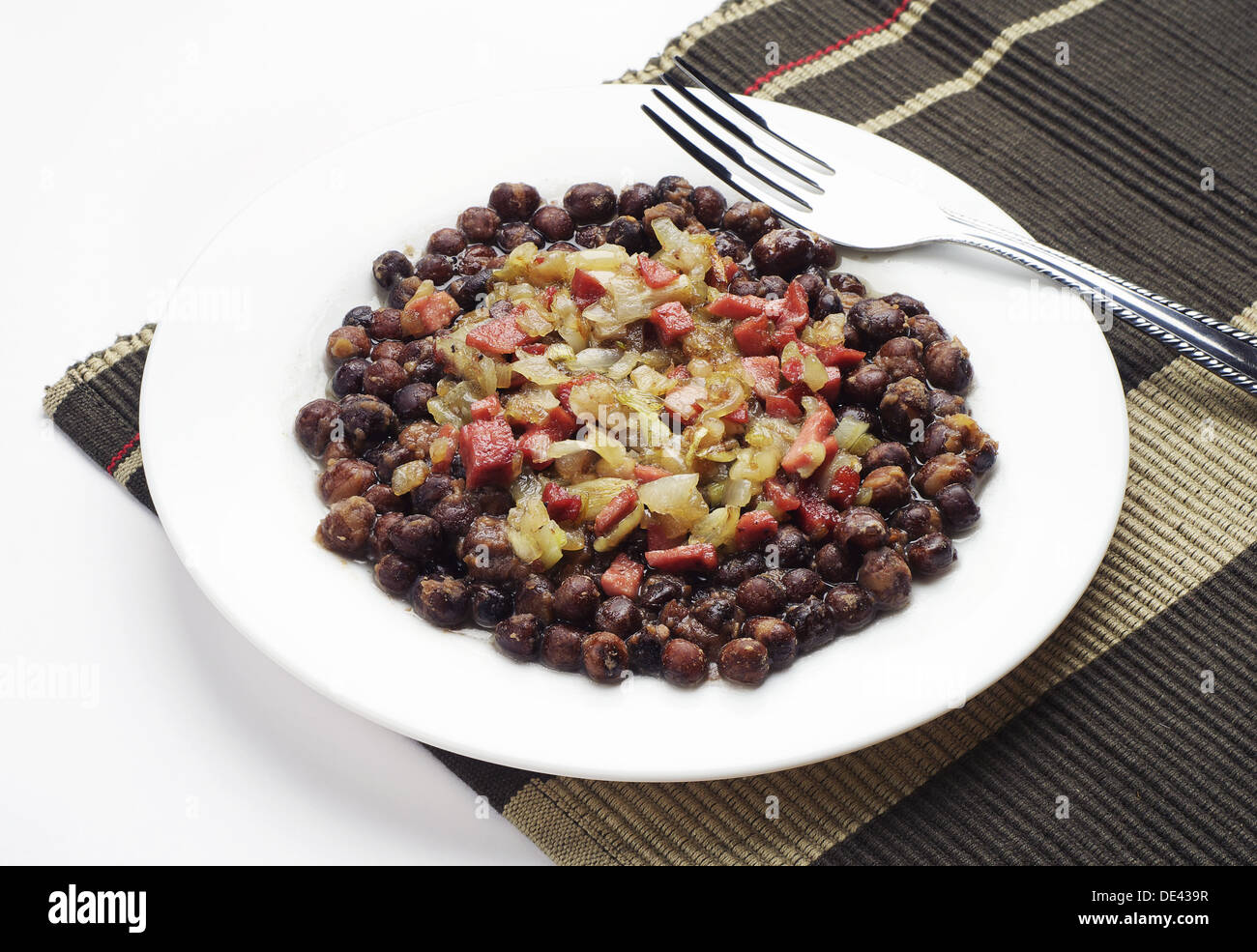 Gray peas with bacon, sausage and onion Stock Photo