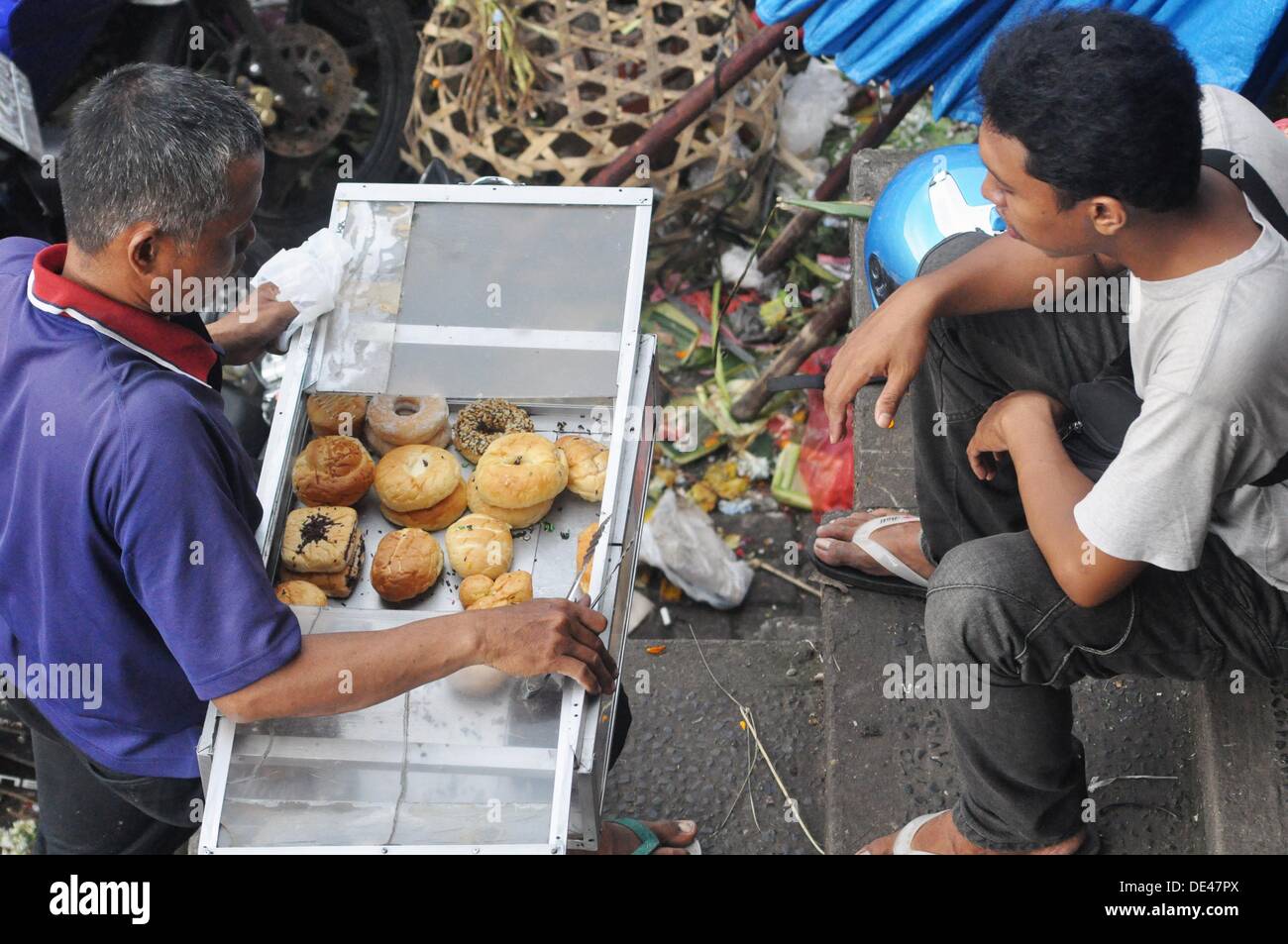 Ubud (Bali, Indonesia) a pastries seller at the market with a client