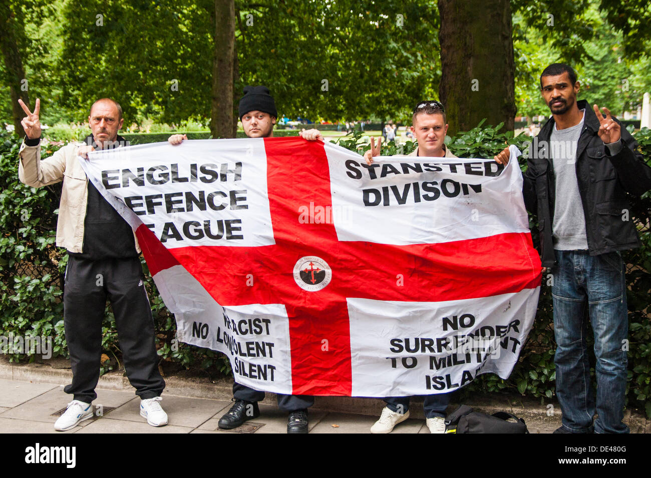 Grosvenor Square, London, UK. 11th Sep, 2013. English Defence League activists including their leader Tommy Robinson, second from right, pose for pictures after laying flowers at the 9/11 memorial in Grosvenor Square, London on the anniversary of the terrorist attacks on America. Credit:  Paul Davey/Alamy Live News Stock Photo