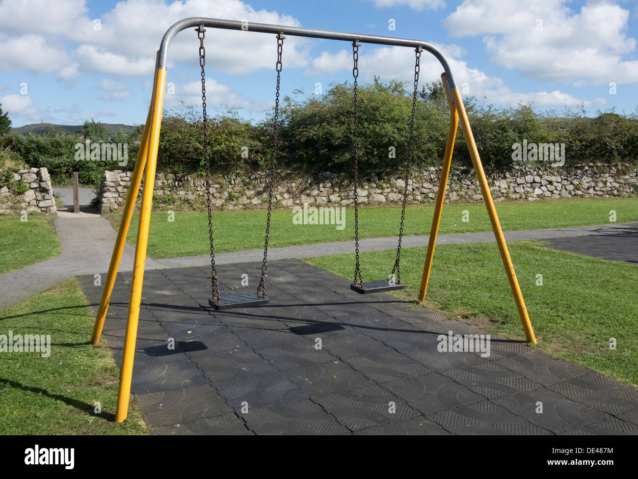 Children's swings in a play area. Stock Photo