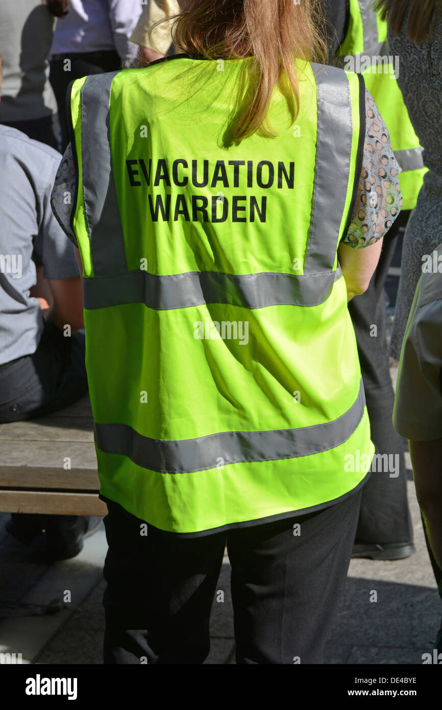 Close up of high visibility vest worn by evacuation warden during practice mass office workforce fire drill Stock Photo