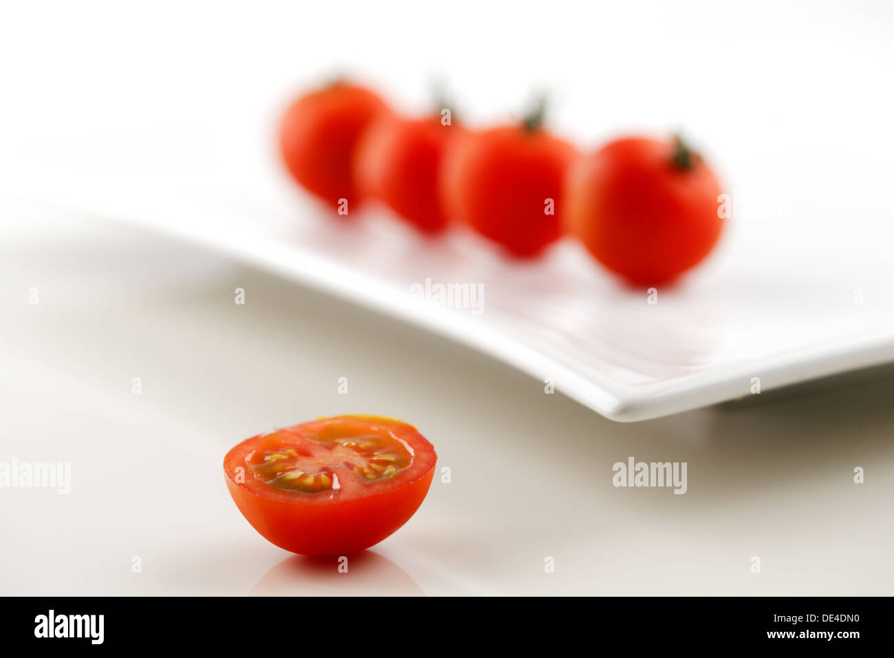 Organic vine tomatoes shot against a white background Stock Photo - Alamy