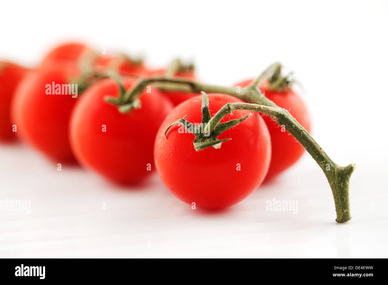 Organic vine tomatoes shot against a white background Stock Photo - Alamy