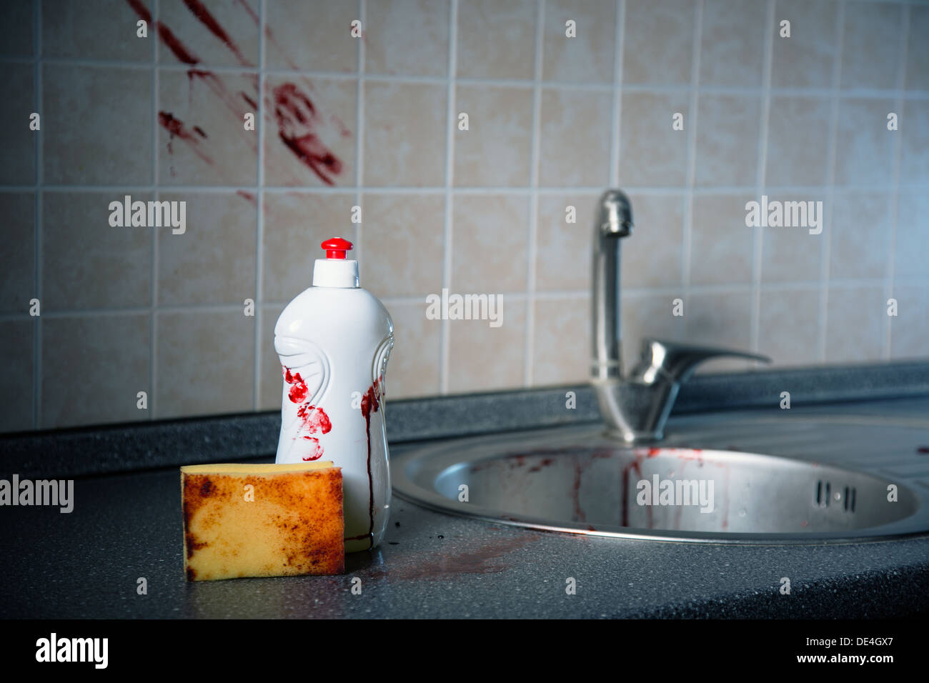 Bottle of dishwashing liquid, sponge and tile with bloody fingerprints, Halloween or criminal concept  Stock Photo