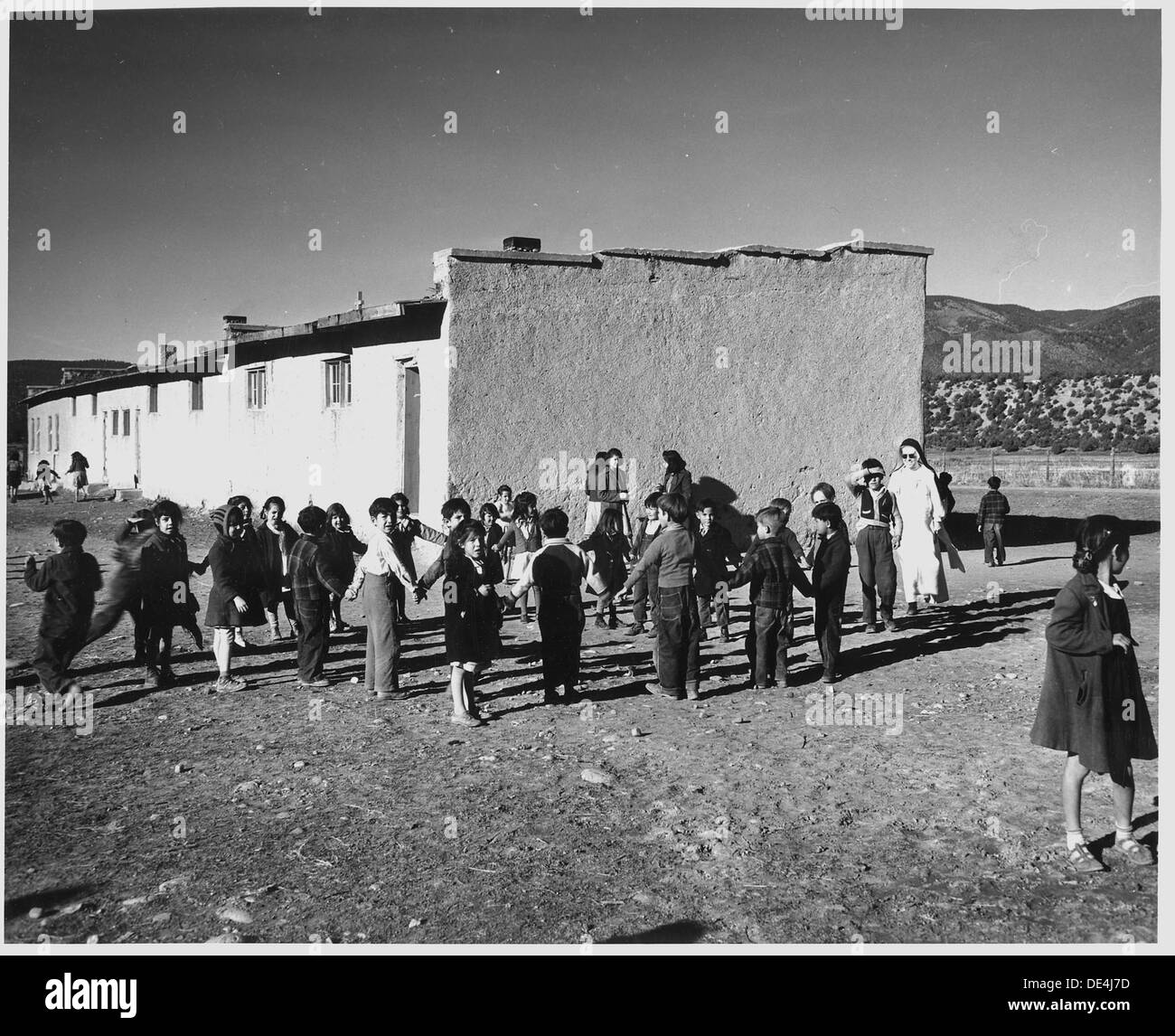 Taos County, New Mexico. Children play in the Penasco schoolyard. School was built by the Catholic . . . 521831 Stock Photo