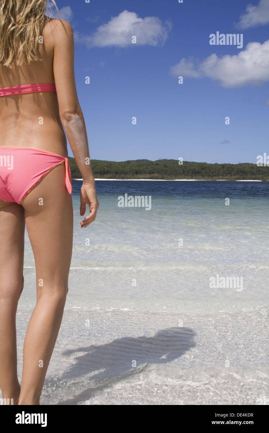 Woman in bikini standing in a beautiful lake, seen from behind. Fraser  Island, Australia Stock Photo - Alamy