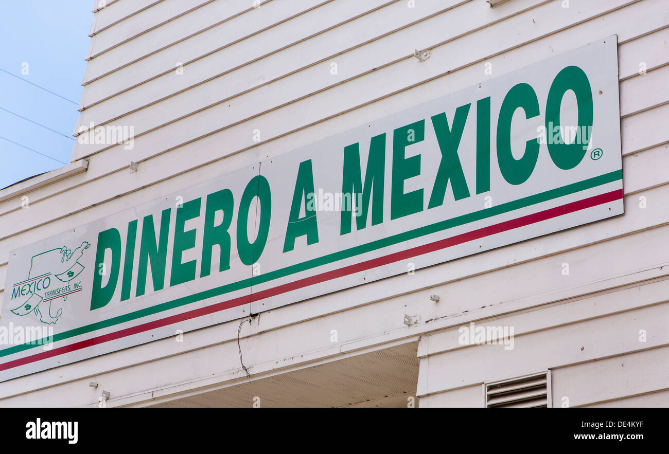 WOODBURN, OREGON, USA - Dinero a Mexico sign on storefront that offer remittance service to Mexican immigrant community. Stock Photo