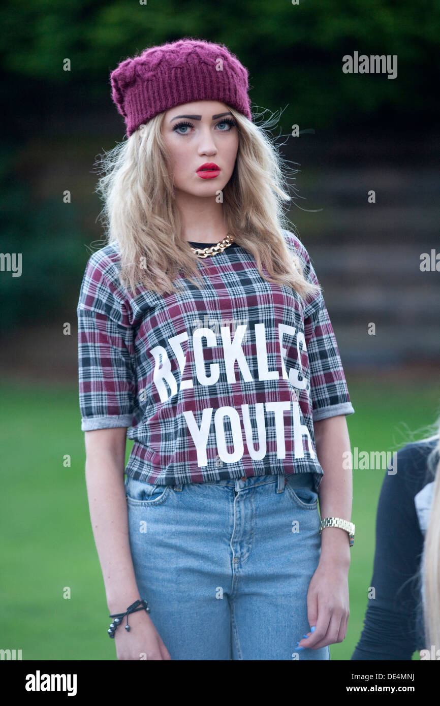 Teenage girl standing in a park. Stock Photo