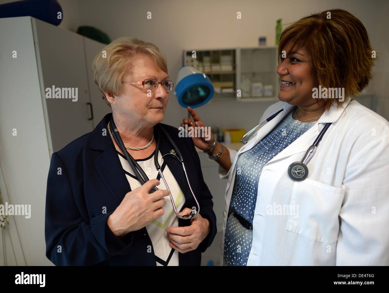 US doctor Elizabeth Beltre talks to her predecessor Dagmar Teichert at
