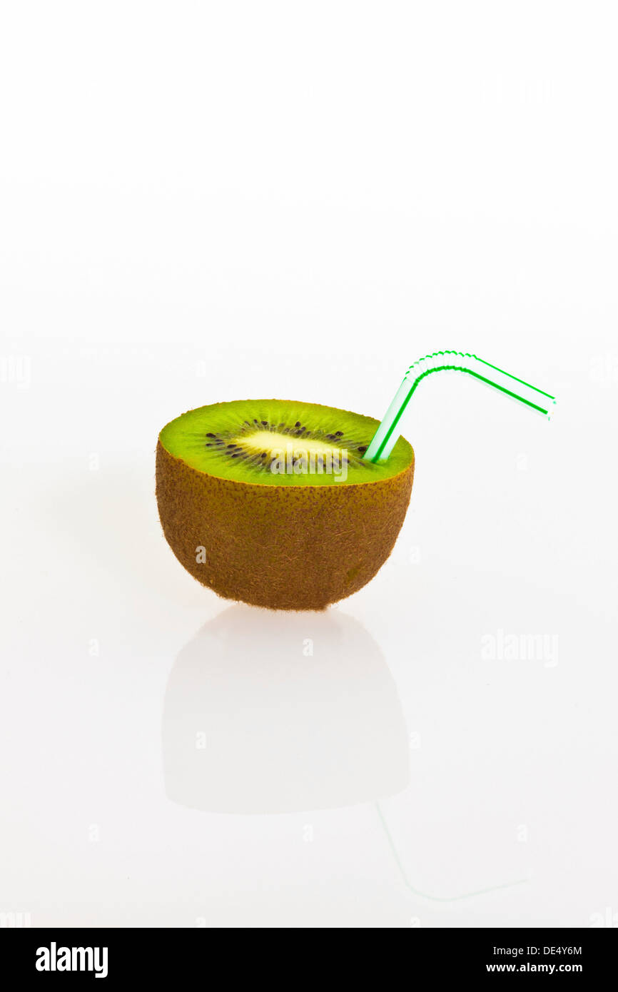 Kiwi fruit with a drinking straw as a soft drink Stock Photo