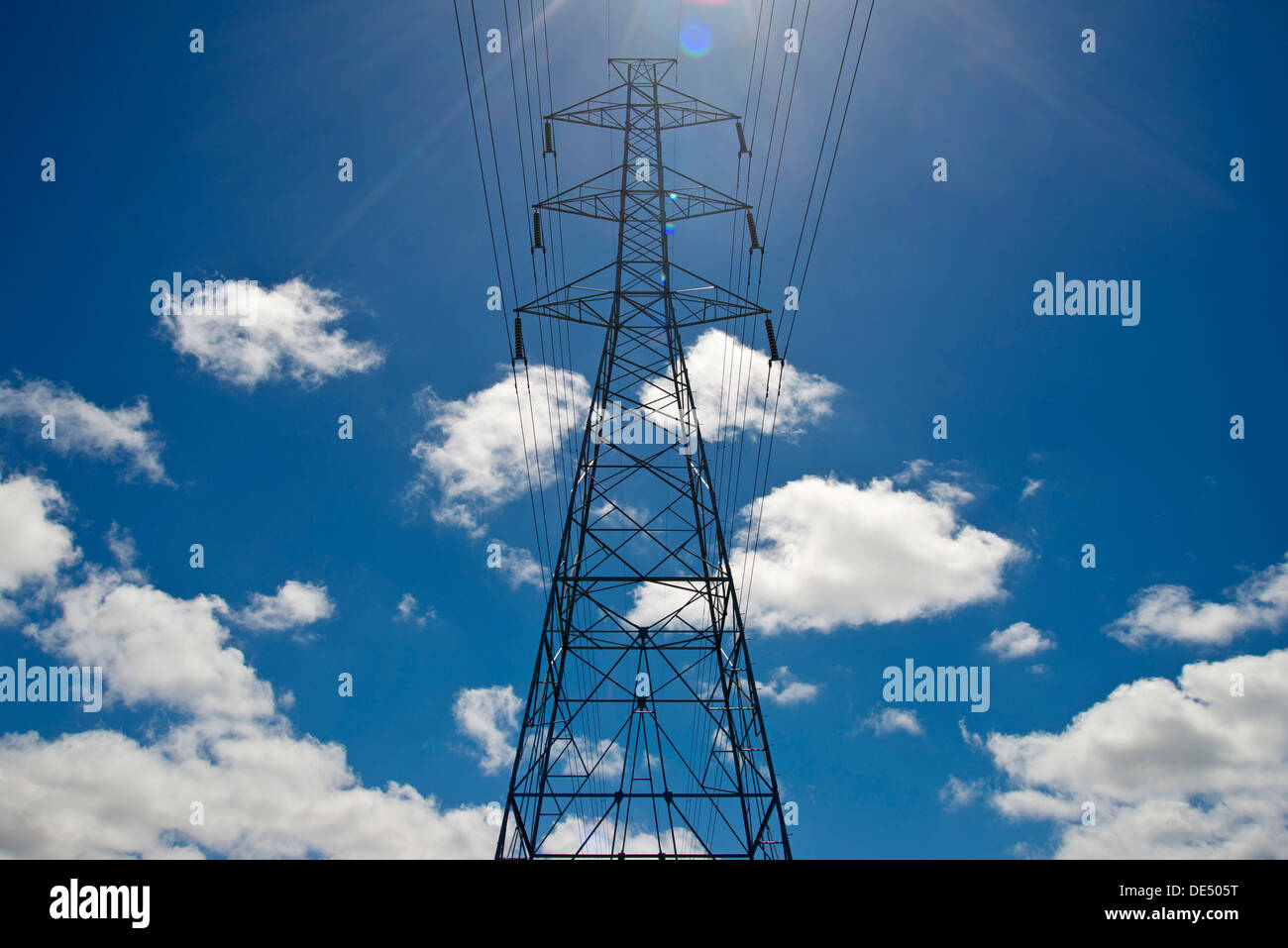 Electricity pylon against a blue sky with clouds Stock Photo - Alamy