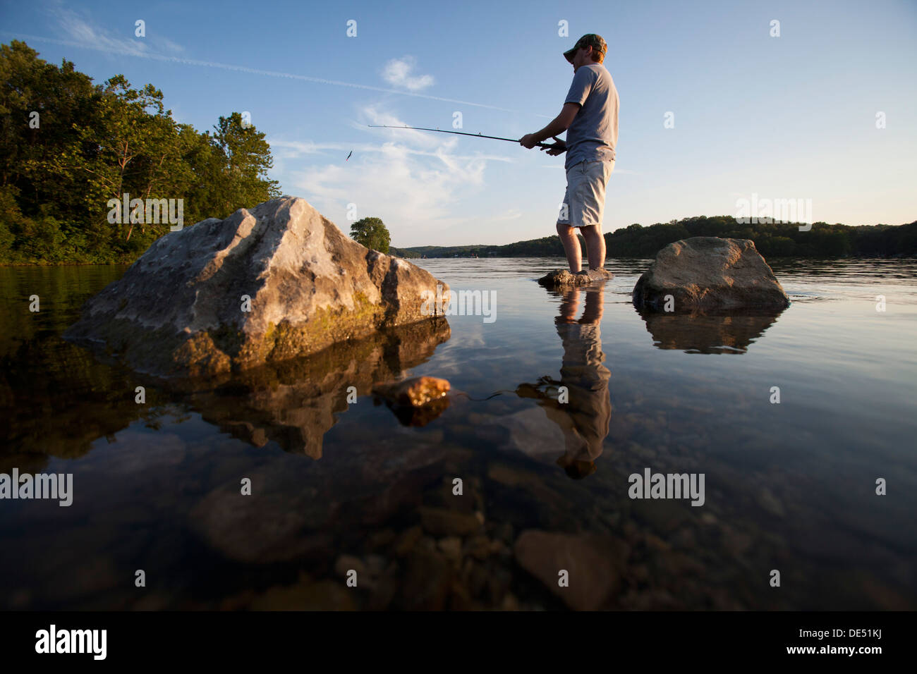 A man casts his line while fishing on Lake Windsor in Bella Vista, Arkansas. Stock Photo
