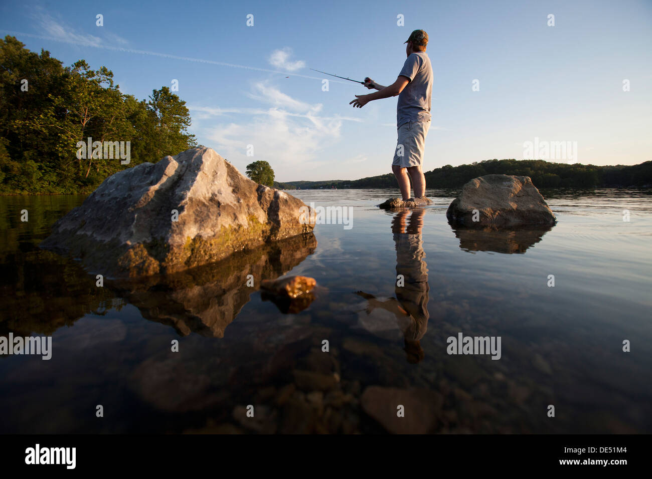 https://c8.alamy.com/comp/DE51M4/a-man-casts-his-line-while-fishing-on-lake-windsor-in-bella-vista-DE51M4.jpg