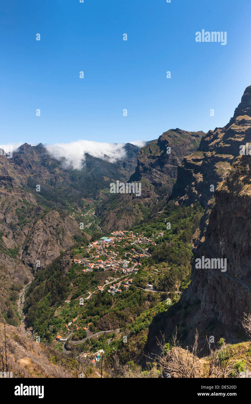 View of the village of Curral das Freiras seen from Pico dos Barcelos mountain, with its deep gorges, Curral das Freiras Stock Photo