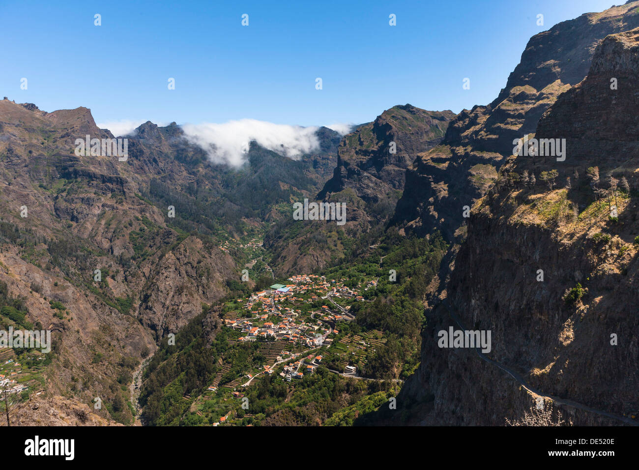 View of the village of Curral das Freiras seen from Pico dos Barcelos mountain, with its deep gorges, Curral das Freiras Stock Photo