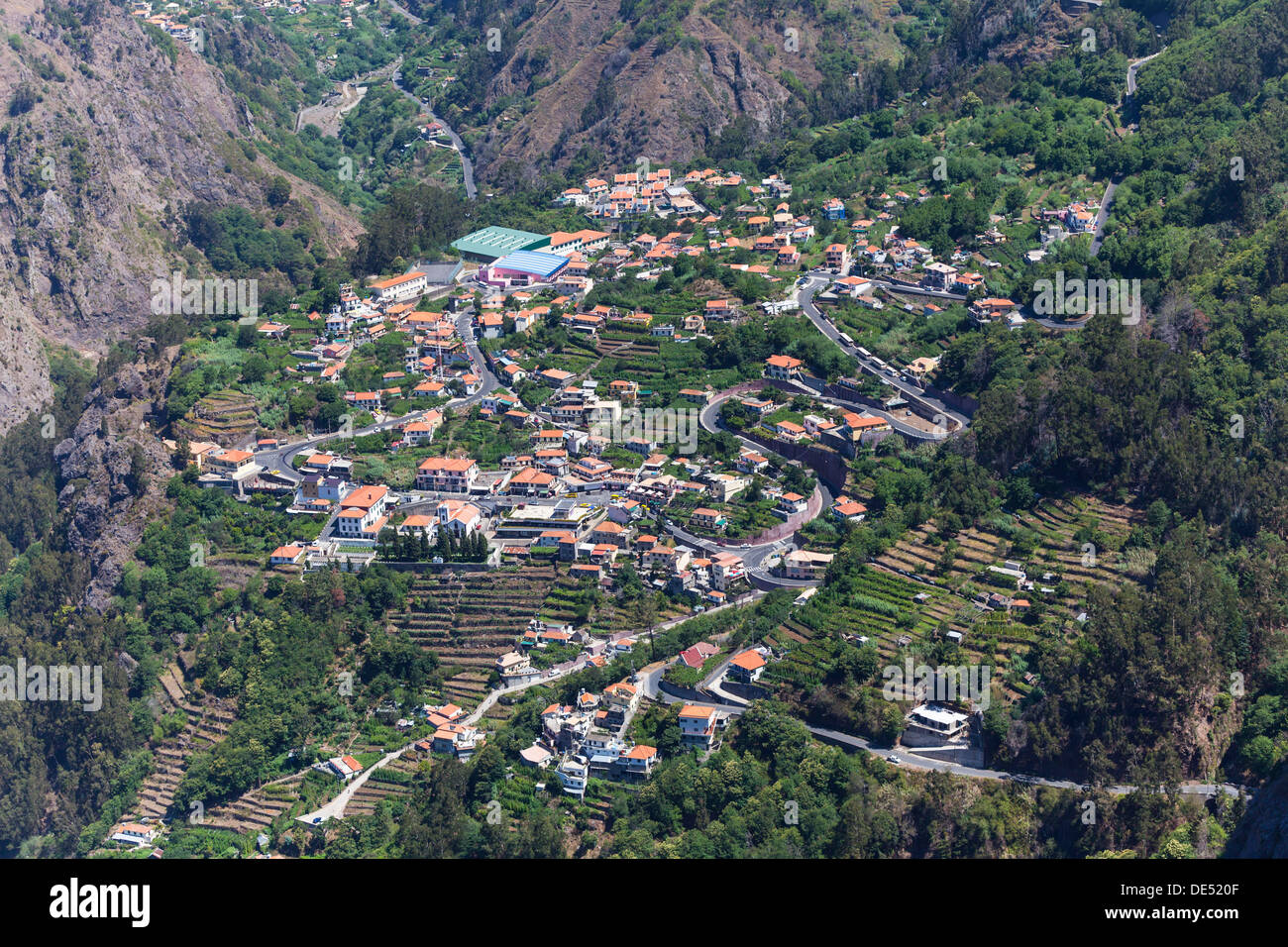 View of the village of Curral das Freiras seen from Pico dos Barcelos mountain, with its deep gorges, Curral das Freiras Stock Photo