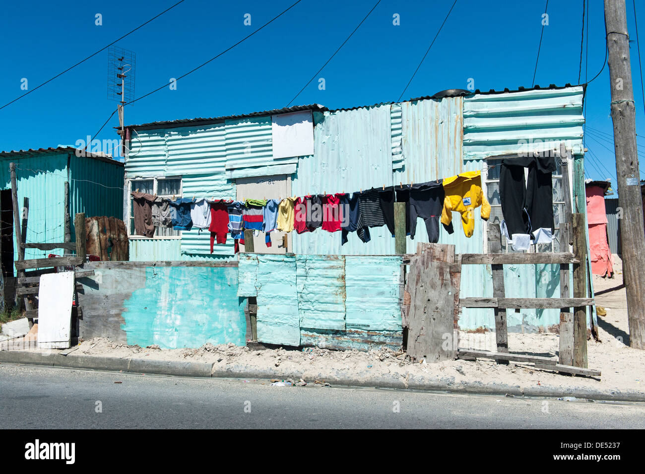 Laundry hanging in front of a tin shack in Khayelitsha, a partially