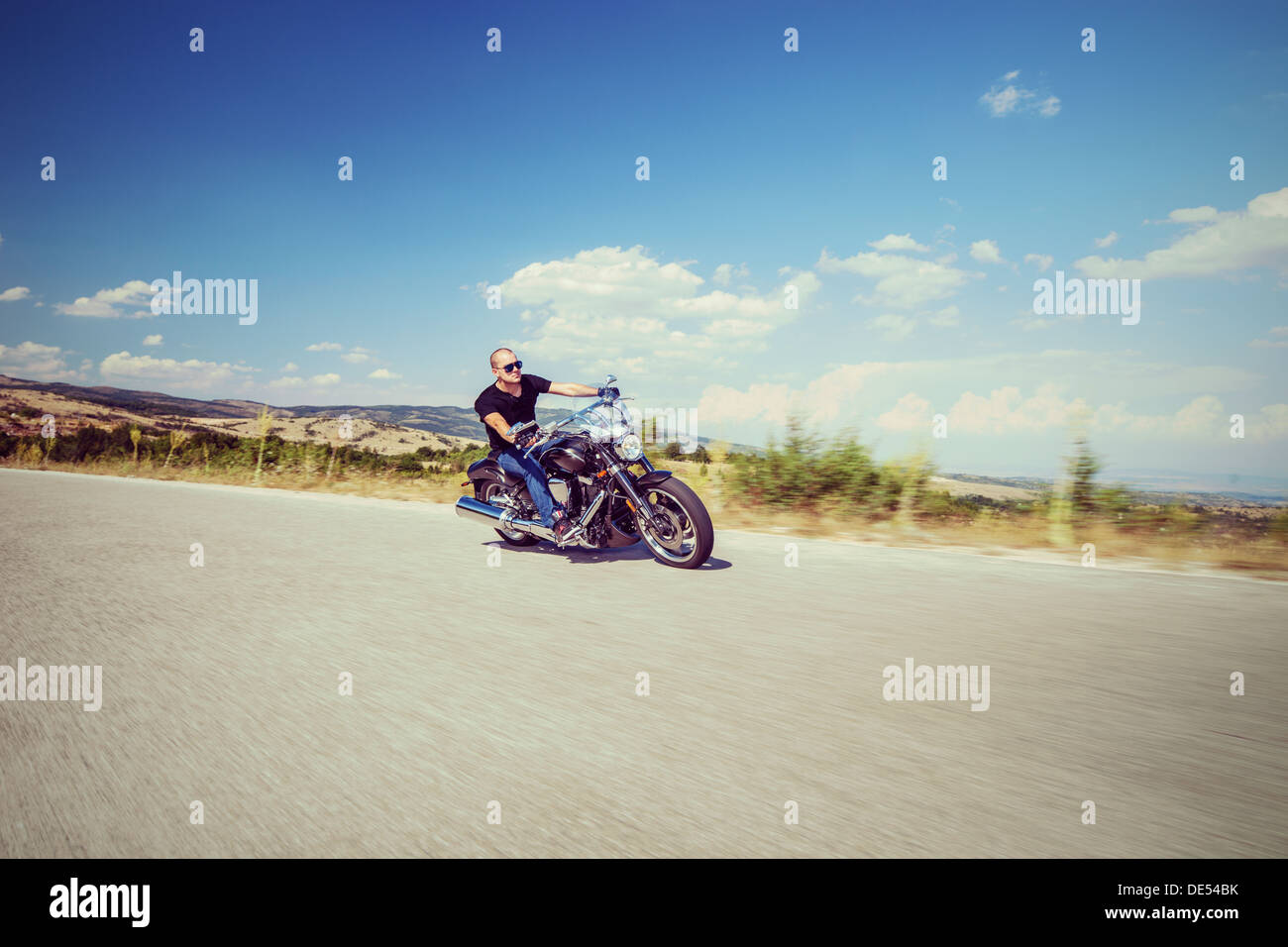 Young biker riding a customized motorcycle Stock Photo