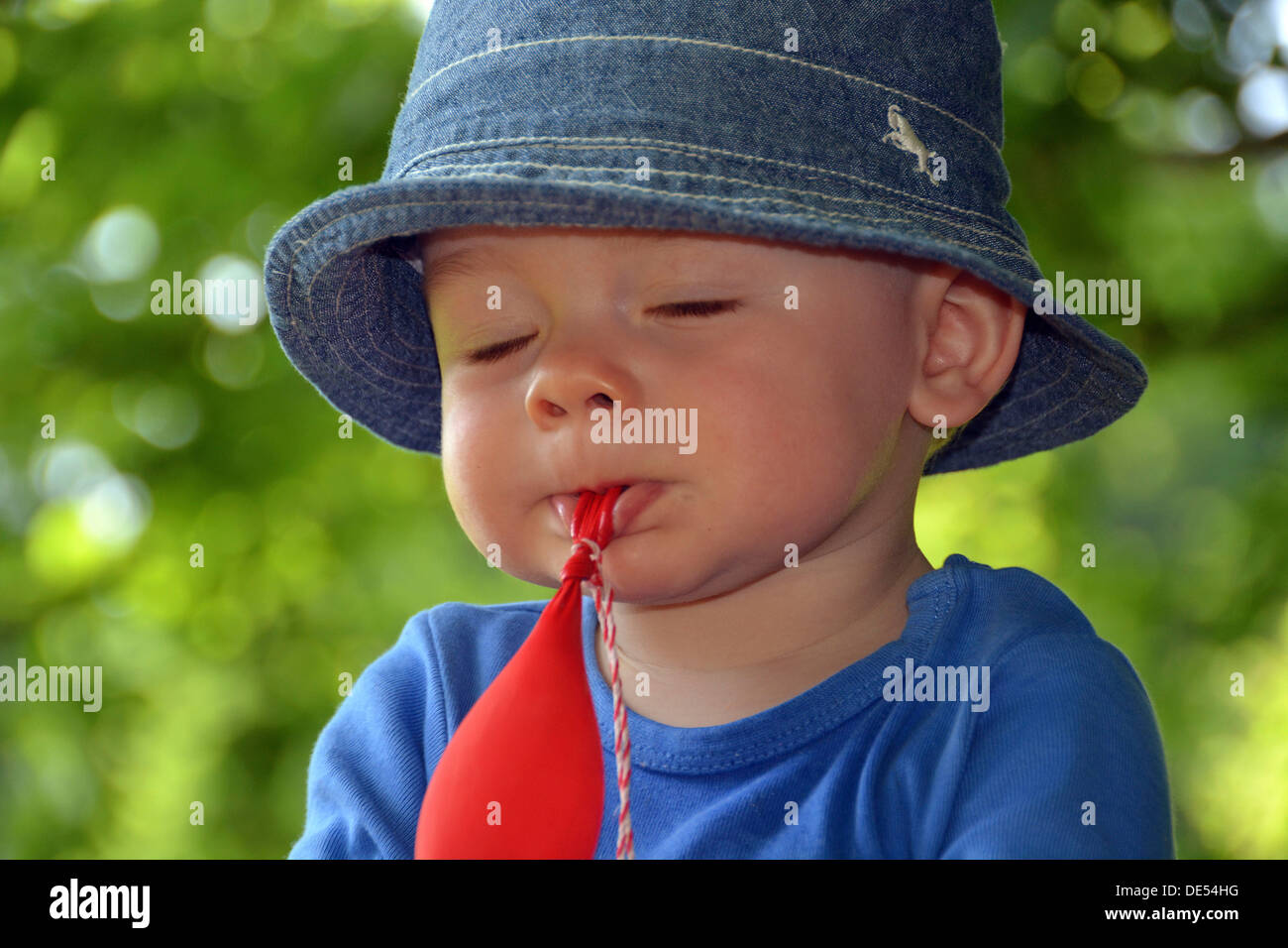 Toddler playing absent-minded with a balloon, Germany Stock Photo