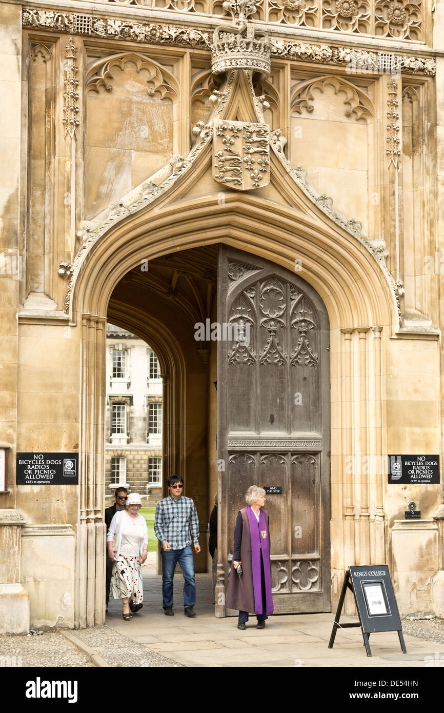 Tourists leaving King's College via the gatehouse, University of Cambridge, England Stock Photo