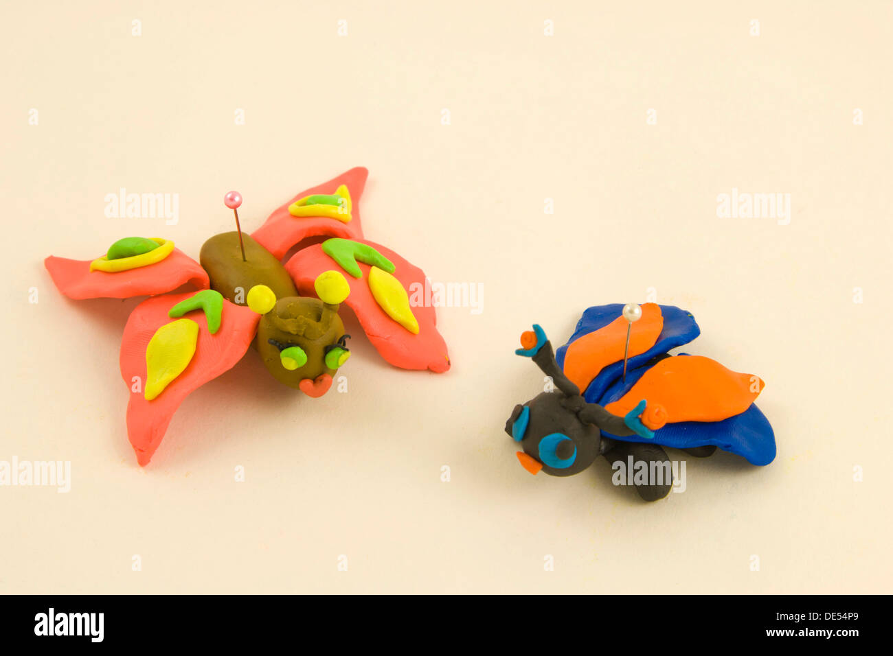 Plasticine figurines, two butterflies on a pin Stock Photo