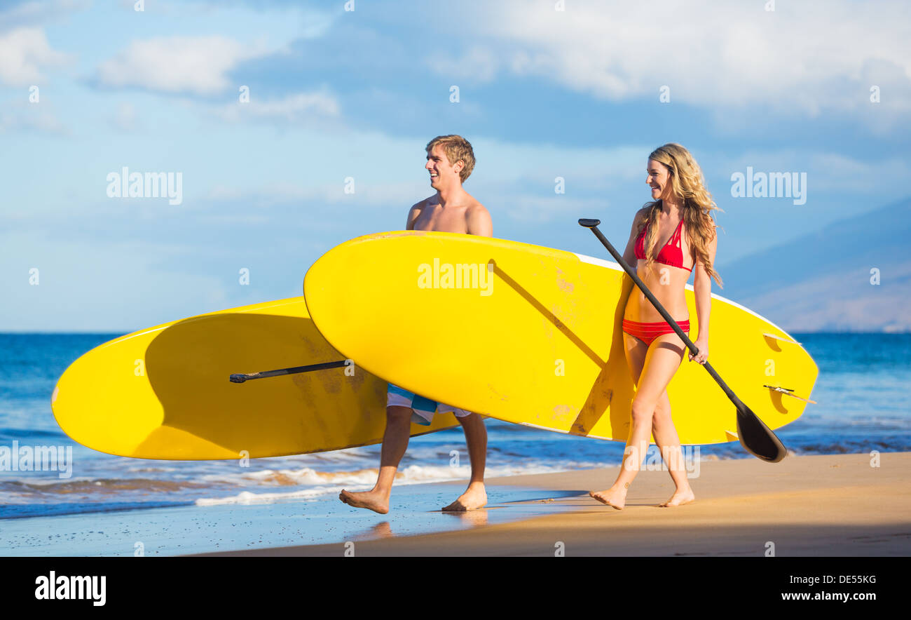 Attractive Couple Stand Up Paddling in Hawaii, Active Life Concept Stock Photo