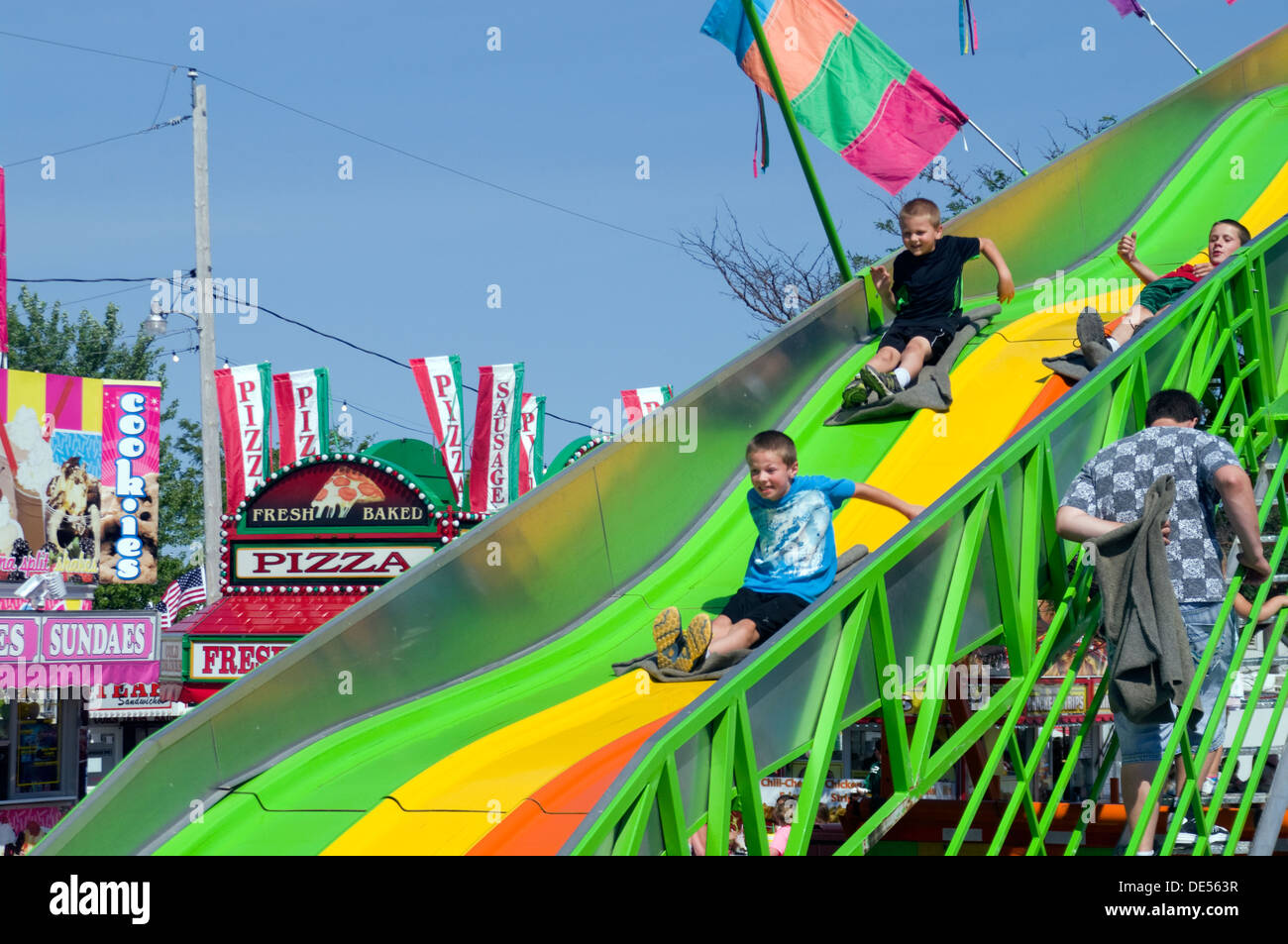 Three boys on Super Slide carnival ride at Manitowoc, Wisconsin County Fair Stock Photo