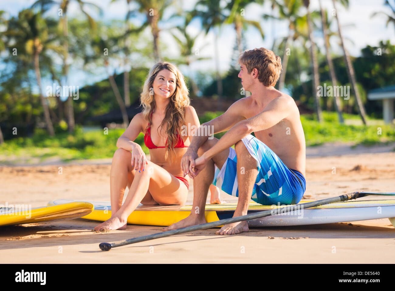 Attractive Couple Stand Up Paddling in Hawaii, Active Life Concept Stock Photo