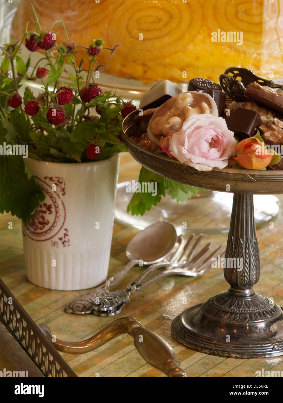 Chocolates in an antique bowl on a stylishly decorated coffee table Stock Photo