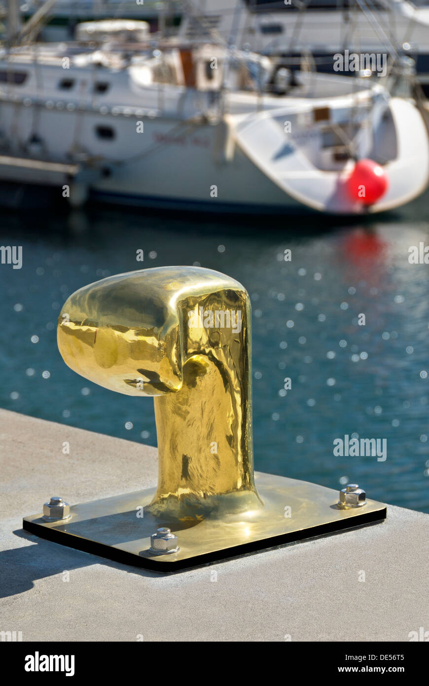 Gold reflective mooring post in chic Puerto Calero a luxury marina in southern Lanzarote Canary Islands Spain Stock Photo