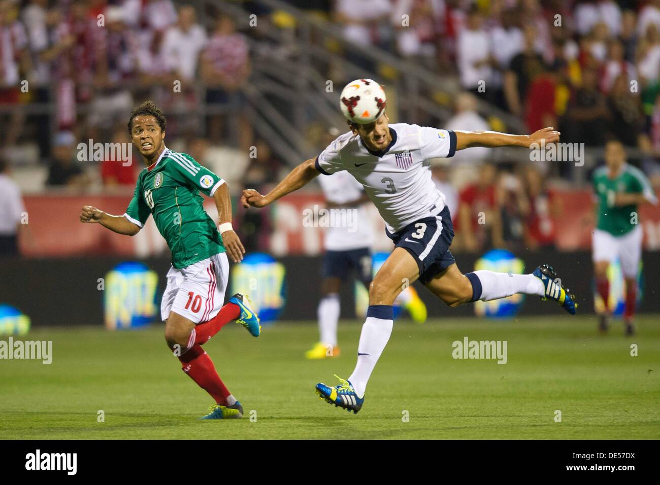 Columbus, Ohio, USA. 10th Sep, 2013. September 10, 2013: US Men's National Team defender Omar Gonzalez (3) heads the ball away from Mexico National Team forward Giovani Dos Santos (10) during the U.S. Men's National Team vs. Mexico National Team- World Cup Qualifier match at Columbus Crew Stadium - Columbus, OH. The United States Men's National Team defeated The Mexico National Team 2-0 and clinched a spot for the World Cup in Brazil. © csm/Alamy Live News Stock Photo
